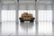 Heavy Military Tank in Modern Hangar with Large Windows.