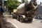 Heavy mixer concrete truck rushing towards under construction building site.