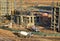 Heavy mixer concrete truck waiting for to be loaded concrete at a construction site. Tower crane lifting a concrete bucket for