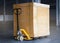 Heavy Package Box Wrapped Plastic Film on Pallet with Hand pallet Truck. Cargo Shipment. Shipping Warehouse.