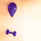 A heavy purple dumbbell flies hanging from a purple balloon on an orange background