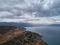 Heavy rain clouds above gulf and dirt roads. aerial view