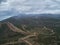 Heavy rain clouds above valley and dirt roads. aerial view