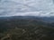 Heavy rain clouds above valley and dirt roads. aerial view