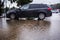 Heavy rain in Israel: a car parked in a parking lot floods with rain, puddle turns to flood