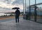 Heavy Rain Man with umbrella under rain in windows vitrines reflection of cruise ship