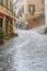 Heavy rain on a street with running rainwater