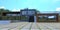 Heavy rectangular concrete pavers in the courtyard in front of a country private house in a minimalist style. Facade decoration