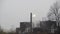 Heavy smog from industry. Heavy industrial and traffic air pollution in town. Factory chimney blowing pollution.