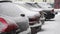 Heavy snow white snowflakes on parked cars