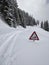 Heavy snowfall causes warning signs to sink into the pass road. Ski tour on the silver mountain. Winter landscape.