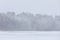 Heavy snowfall at lake shore landscape