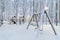 Heavy snowfall in Moscow, children`s playground under the snow. Collapse of public services