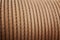 Heavy steel coiled greased cable detail in warm tone