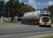 A heavy storage vessel hauled by multi wheeled transporter through rural Victoria