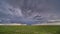 Heavy storm cloud over green prairie