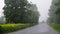 Heavy summer rain on the road outside the city