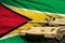 Heavy tank with fictional design on Guyana flag background - modern tank army forces concept, military 3D Illustration