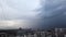 Heavy thunderstorm over a big city. Stormy front goes into the distance. Weather cataclysm, rainy storm.