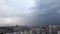 Heavy thunderstorm over a big city. Stormy front goes into the distance. Weather cataclysm, rainy storm.