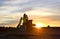 Heavy tracked excavators at a construction site on a background sunset. Special heavy construction equipment for road construction