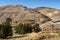 Heavy Trucks Hauling Loose Rock in Open Pit Gold Mine