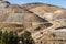 Heavy Trucks Hauling Loose Rock in Open Pit Gold Mine