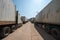 Heavy trucks loaded with goods trailers, parked in waiting area on state border crossing in Vietnam