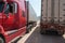 Heavy trucks loaded with goods trailers, parked in waiting area on state border crossing in Vietnam