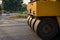 Heavy vibration yellow steamroller or soil compactor working on hot-mix asphalt pavement road