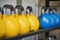 Heavy weight sets of kettlebell on iron racks at the gym used for functional fitness, high intensity CrossFit training, weight lif