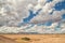 Heavy White Clouds Over The Desert Landscape