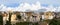 Heavy white clouds rising above old town buildings