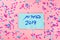 Hebrew text :Elections 2019 on voting paper over pink with colorful confetti background.