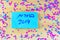 Hebrew text Elections 2019 on voting paper over wooden board with confetti background.