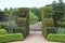 Hedge lined gravel pathway to secret garden