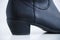 Heel close-up  black cowboy boots on a white background