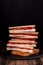 Heep of sandwiches toasted bread and salami on black. fast food unhealthy concept