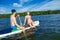 Ñheerful young couple sitting on the board stand up paddle boar