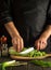 Ð¡hef prepares a delicious salad for breakfast. Chinese cabbage sliced on a cutting board in kitchen