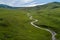 From the height of the green river valley in the mountains at the height of the clouds in the morning. River and green meadows fro