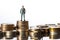 Heights of Success Miniature Man Standing on Money, Illustrating a Business Concept of Comparison and Achievement. created with