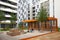 Heilbronn, Germany - August 12, 2019. Moms with young children play in the sandbox on the playground between modern buildings. The