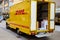 Heilbronn, Germany - August 9, 2019: Car with the DHL logo. Unloading goods. DHL - an international company for the fast delivery