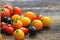 Heirloom variety tomatoes on rustic table. Colorful tomato - red,yellow , black, orange. Harvest vegetable cooking conception