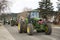 Helena, Montana - April 19, 2020: Farmers in green tractors decorated with American flag drive around Capitol square protesting