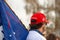 Helena, Montana / Nov 7, 2020: White man wearing Trump 2020 MAGA red hat holding Trump flag at Stop the Steal rally in the Capital