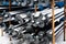 Helical piles on rusty metal rack in snowy warehouse yard