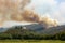 Helicopter against wildfire during strong wind and drought near Miren Castle in Slovenia