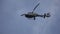 Helicopter in the cloudy sky with lightning. Helicopter From Below Flying Through Cloudy Sky. Helicopter hovering